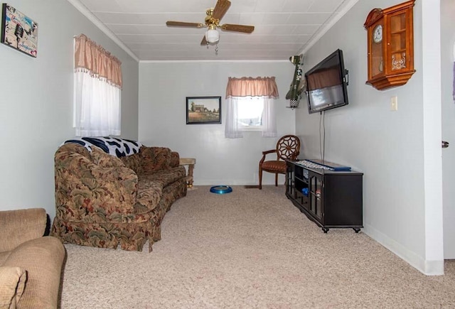 carpeted living room with ceiling fan and crown molding