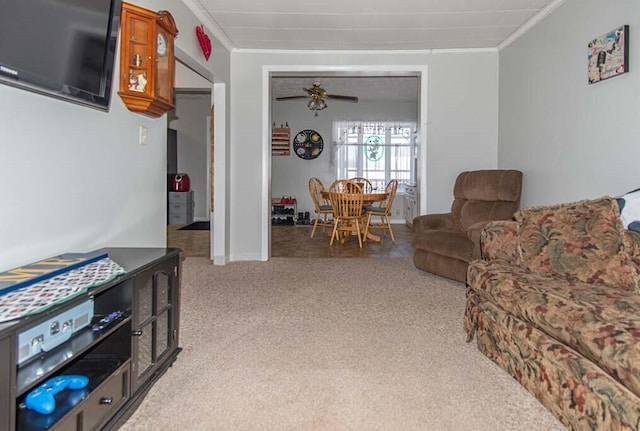 carpeted living room featuring ceiling fan and crown molding