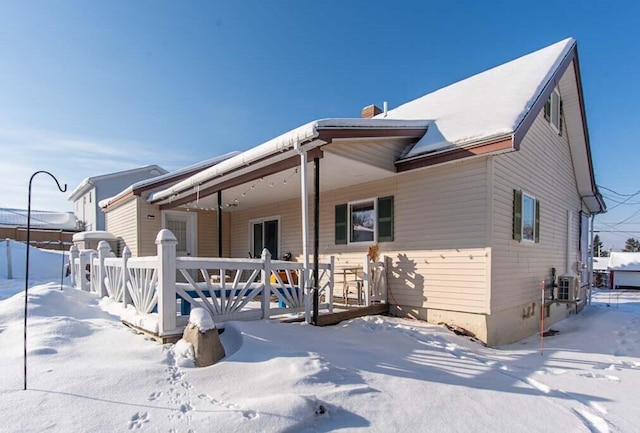 snow covered house with a porch