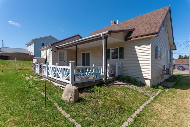 186 Mountain View Ave, Madawaska, ME 04756 - back of house with a wooden deck, a shingled roof, a lawn, and a chimney