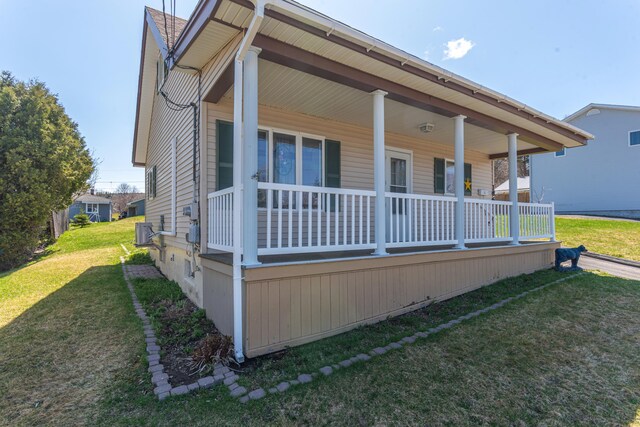 186 Mountain View Ave, Madawaska, ME 04756 - view of front facade with cooling unit, a porch, and a front yard
