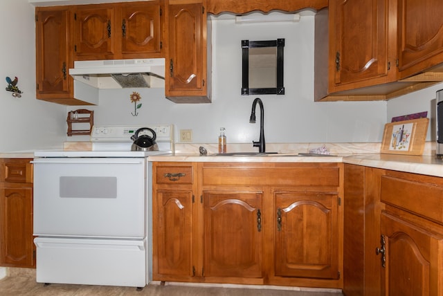 186 Mountain View Ave, Madawaska, ME 04756 - kitchen with white range with electric cooktop, under cabinet range hood, a sink, light countertops, and brown cabinets