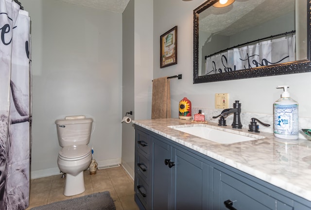 186 Mountain View Ave, Madawaska, ME 04756 - bathroom featuring a textured ceiling, vanity, toilet, tile patterned floors, and baseboards