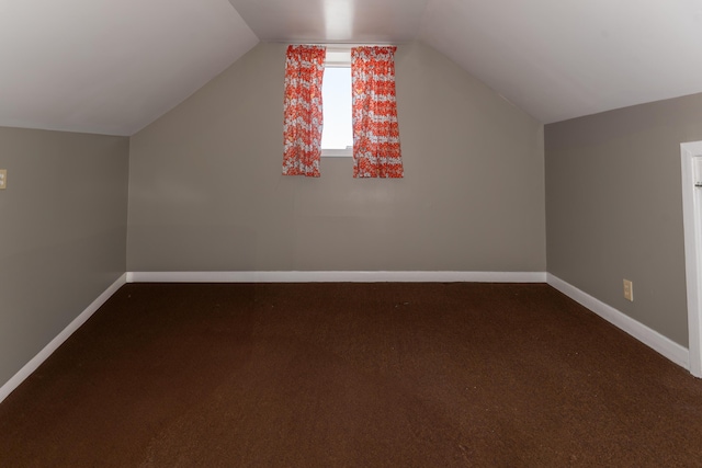 186 Mountain View Ave, Madawaska, ME 04756 - additional living space with baseboards, dark colored carpet, and vaulted ceiling