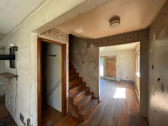 98 White Schoolhouse Rd, Corinth, ME 04427 - interior space featuring a baseboard heating unit and wood finished floors