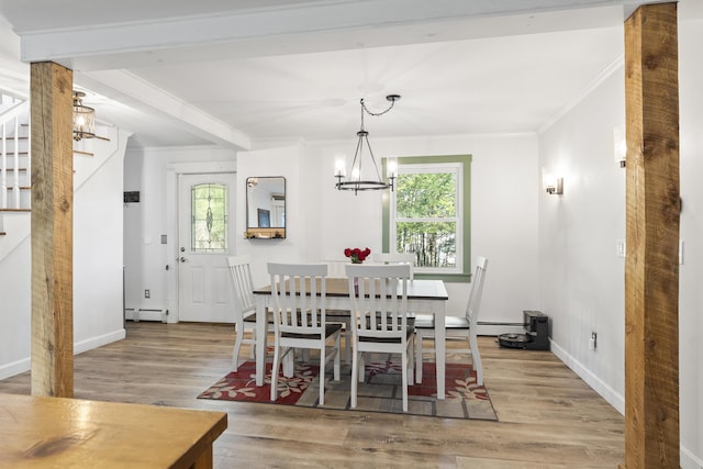 16 Hayden Hill Rd, Litchfield, ME 04350 - dining room featuring a chandelier, ornamental molding, wood finished floors, a baseboard radiator, and baseboards