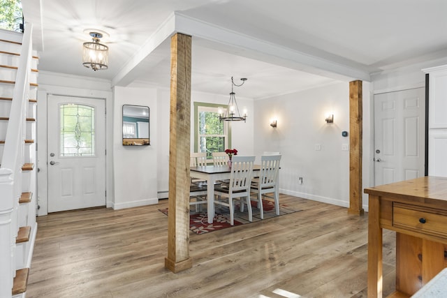 16 Hayden Hill Rd, Litchfield, ME 04350 - foyer entrance with a chandelier, ornamental molding, baseboards, light wood-style flooring, and a baseboard radiator