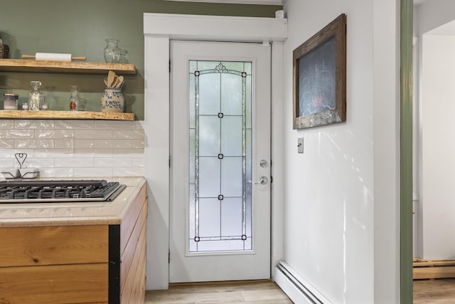 16 Hayden Hill Rd, Litchfield, ME 04350 - doorway featuring light wood-style floors, baseboard heating, and a baseboard heating unit