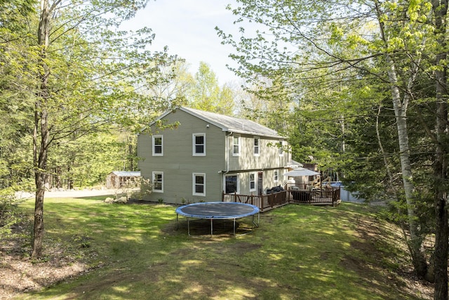 16 Hayden Hill Rd, Litchfield, ME 04350 - rear view of property with a deck, a yard, and a trampoline