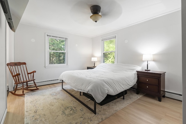 16 Hayden Hill Rd, Litchfield, ME 04350 - bedroom featuring baseboard heating, crown molding, light wood-type flooring, and a ceiling fan