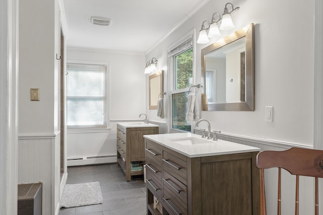 16 Hayden Hill Rd, Litchfield, ME 04350 - full bath with baseboard heating, crown molding, two vanities, and a wainscoted wall