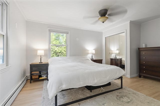 16 Hayden Hill Rd, Litchfield, ME 04350 - bedroom featuring baseboard heating, ornamental molding, light wood-type flooring, ceiling fan, and baseboards