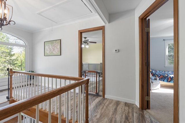 16 Hayden Hill Rd, Litchfield, ME 04350 - corridor featuring attic access, an upstairs landing, wood finished floors, baseboards, and ornamental molding