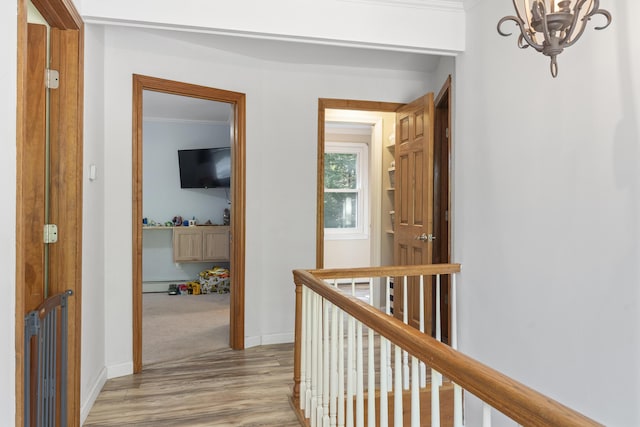 16 Hayden Hill Rd, Litchfield, ME 04350 - hall featuring a chandelier, light wood finished floors, an upstairs landing, baseboards, and ornamental molding