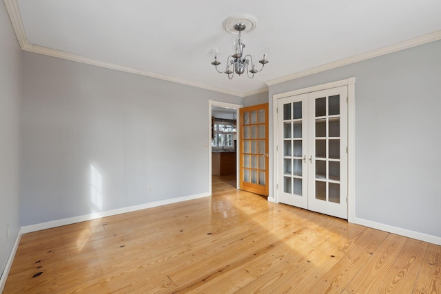 unfurnished dining area with a notable chandelier, french doors, ornamental molding, and wood-type flooring