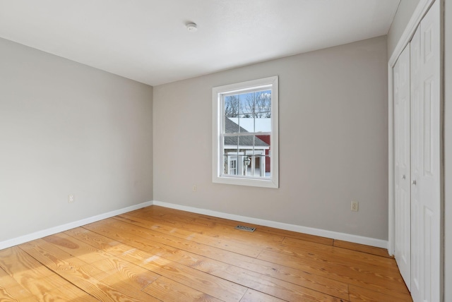 unfurnished bedroom featuring a closet and light hardwood / wood-style floors