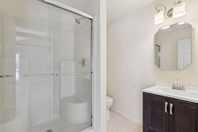 bathroom with vanity, toilet, and a shower with door