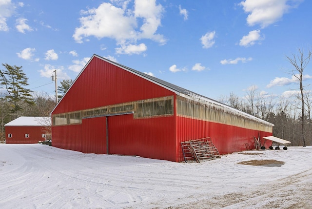 snow covered property with an outdoor structure