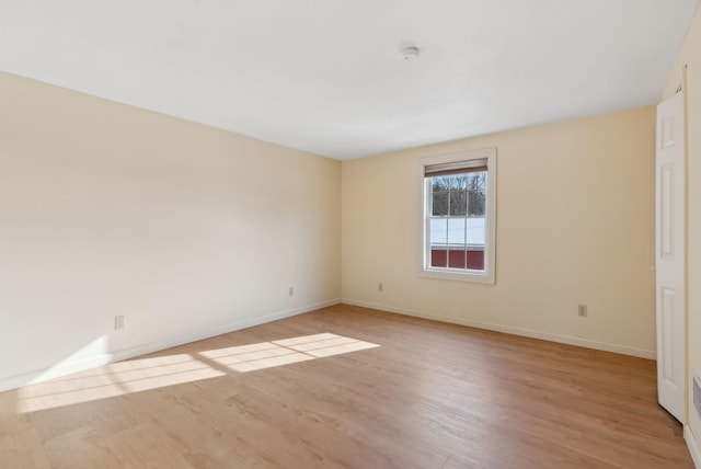 spare room with light hardwood / wood-style floors