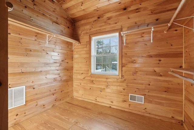 interior space featuring hardwood / wood-style floors and wood walls