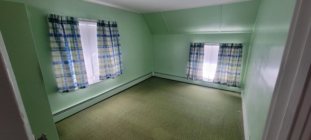 unfurnished room with a baseboard radiator and vaulted ceiling