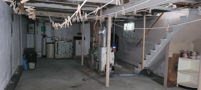 basement featuring electric panel and washer / dryer