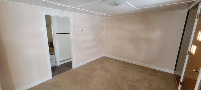 spare room with a baseboard radiator and carpet