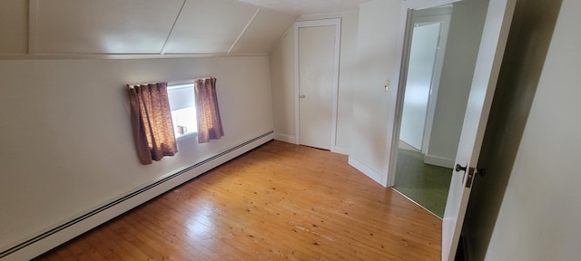 bonus room with vaulted ceiling, light hardwood / wood-style floors, and a baseboard radiator