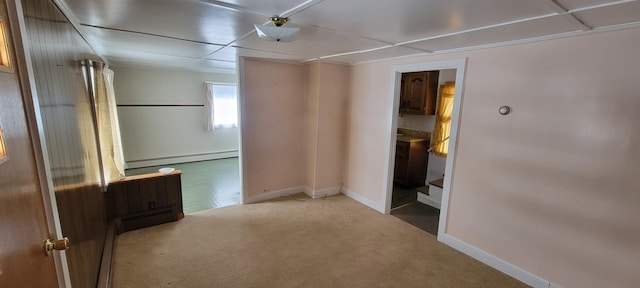 unfurnished room featuring carpet floors and a baseboard radiator