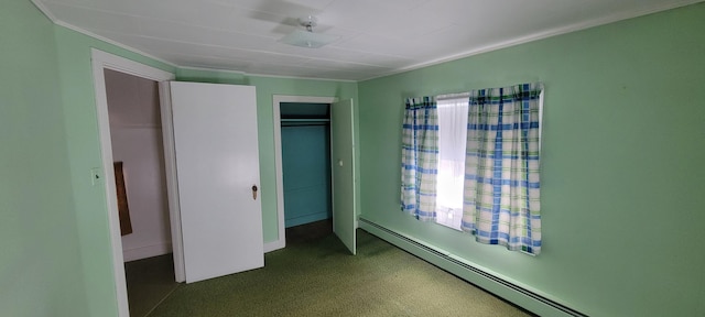 unfurnished bedroom with a baseboard heating unit and a closet