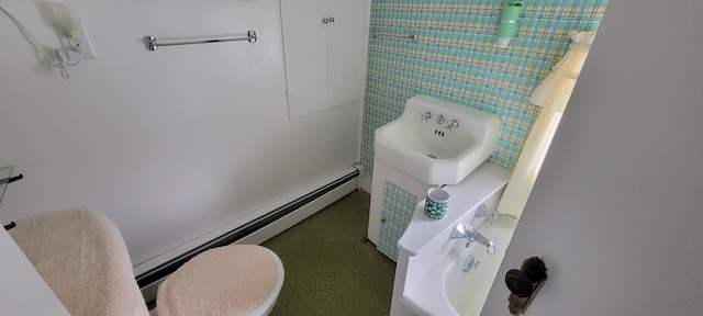 bathroom with a baseboard radiator and toilet