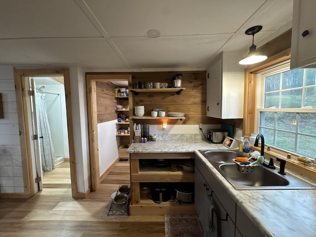 62 Main St, Hiram, ME 04041 - kitchen with light wood-style floors, light countertops, decorative light fixtures, open shelves, and wooden walls
