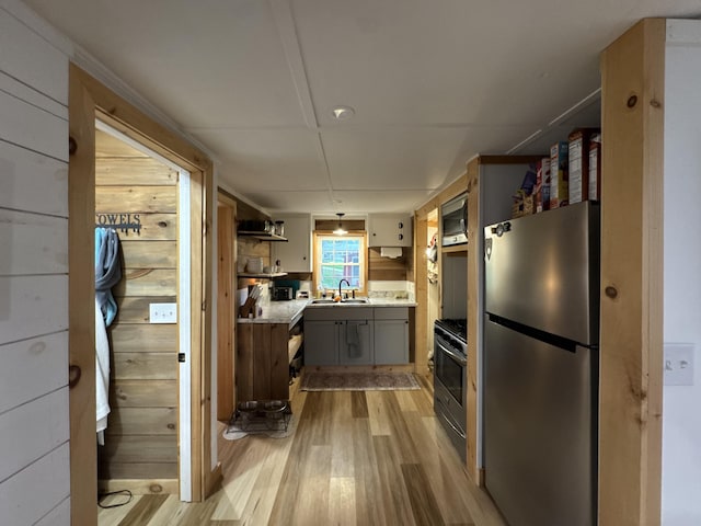 62 Main St, Hiram, ME 04041 - kitchen featuring stainless steel appliances, light wood-style flooring, gray cabinets, and light countertops