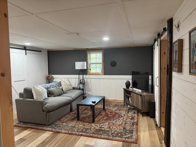 62 Main St, Hiram, ME 04041 - living area featuring a barn door, wood finished floors, wainscoting, and recessed lighting