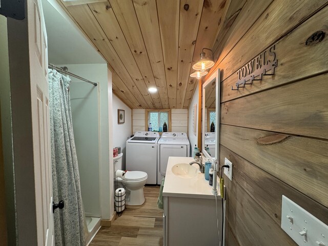 62 Main St, Hiram, ME 04041 - bathroom featuring washing machine and dryer, wood finished floors, vanity, wooden ceiling, and a stall shower