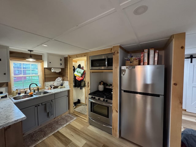 62 Main St, Hiram, ME 04041 - kitchen with appliances with stainless steel finishes, light wood-style flooring, gray cabinets, and light countertops
