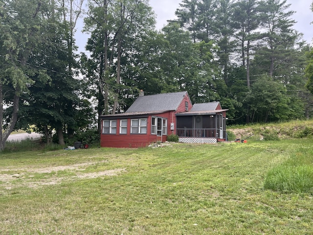 62 Main St, Hiram, ME 04041 - rear view of house with a sunroom, a yard, a shingled roof, and a chimney