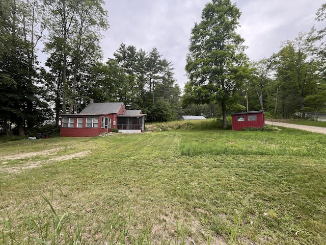 62 Main St, Hiram, ME 04041 - view of green lawn with a storage shed and a sunroom