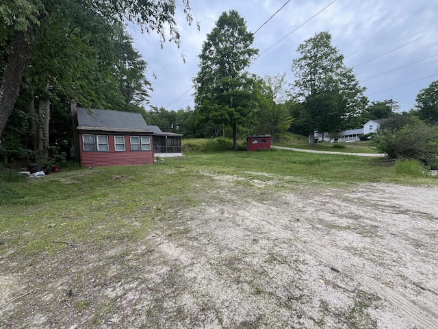 62 Main St, Hiram, ME 04041 - view of green lawn featuring a storage unit and a sunroom