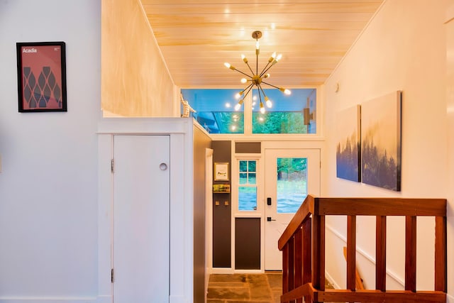 foyer entrance featuring wood ceiling and a notable chandelier