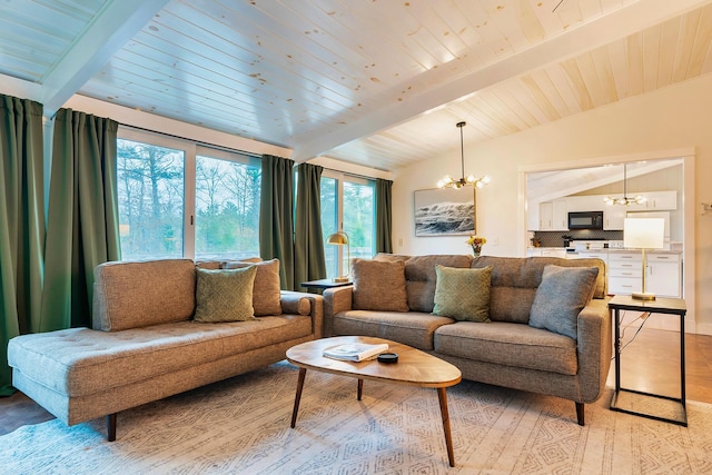 living room featuring light hardwood / wood-style flooring, a chandelier, and vaulted ceiling with beams