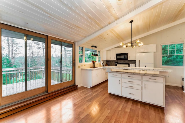 kitchen featuring a center island, pendant lighting, lofted ceiling with beams, white cabinetry, and white refrigerator