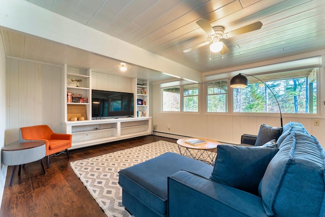 living room featuring baseboard heating, built in features, wood ceiling, and dark hardwood / wood-style floors