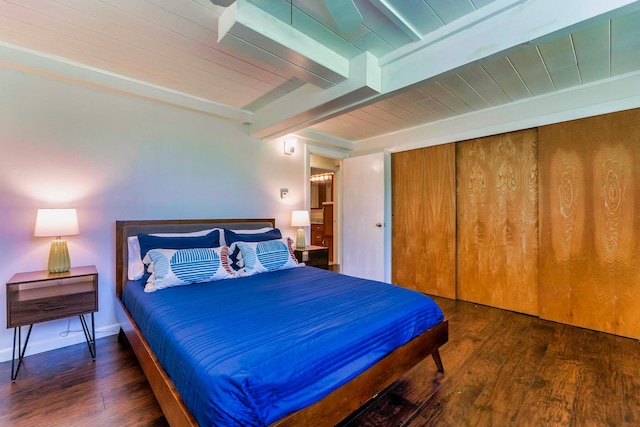 bedroom with dark wood-type flooring and beamed ceiling