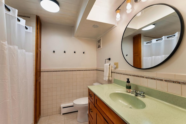 bathroom with toilet, vanity, tile walls, tile patterned flooring, and baseboard heating