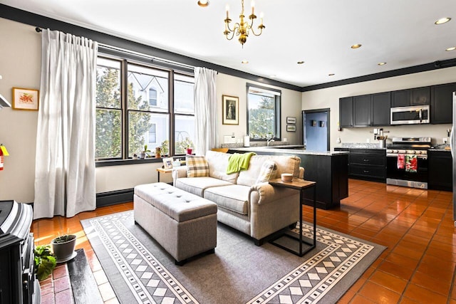 tiled living room featuring ornamental molding and an inviting chandelier