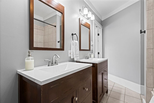 bathroom with tile patterned flooring, ornamental molding, and vanity