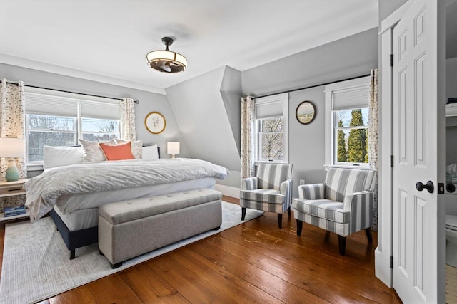 bedroom featuring hardwood / wood-style flooring and lofted ceiling