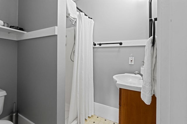 bathroom featuring vanity, curtained shower, and toilet