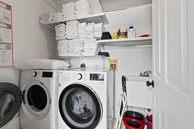 laundry room featuring separate washer and dryer and sink